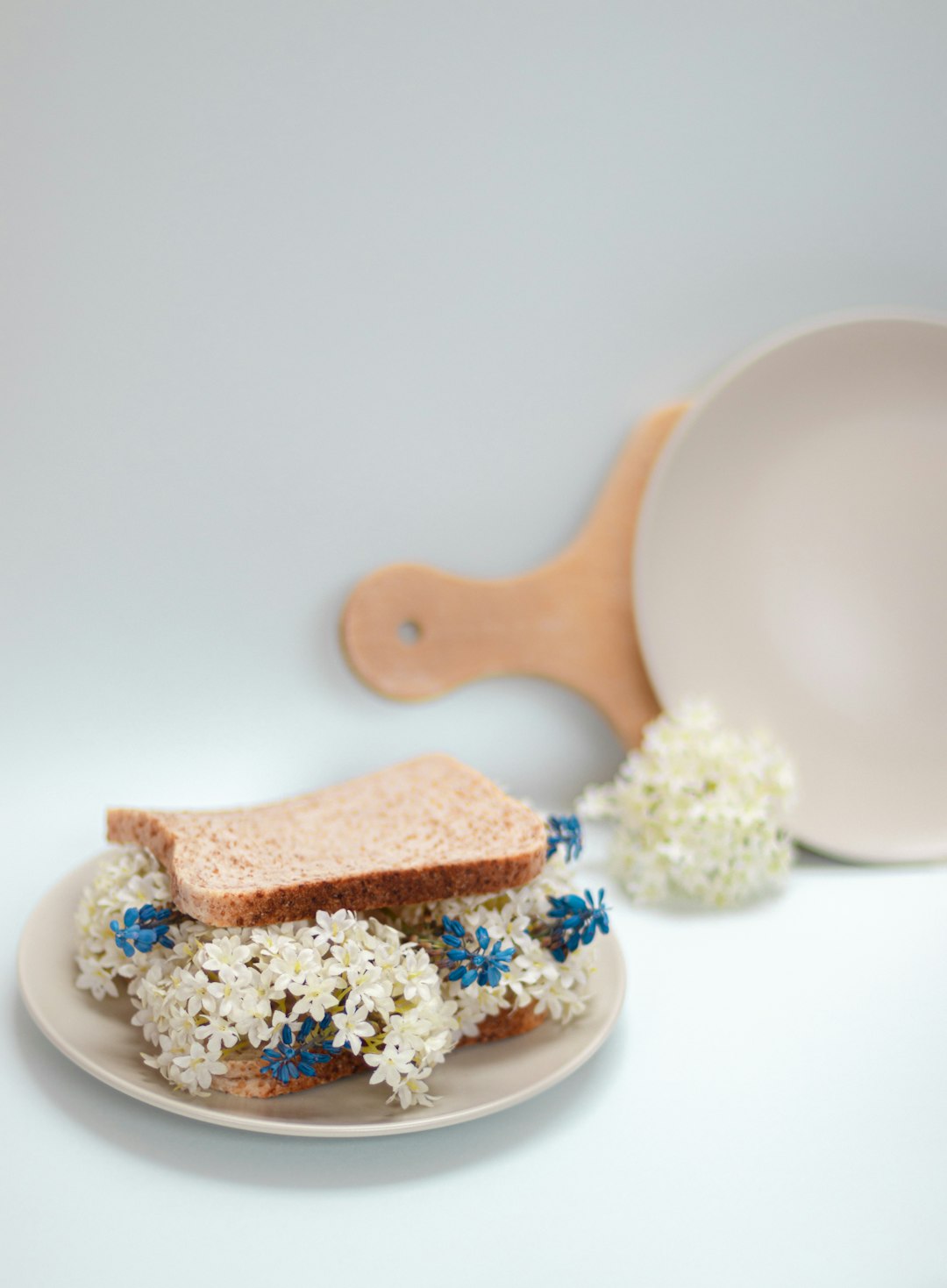 brown wooden spoon on white and blue floral ceramic plate