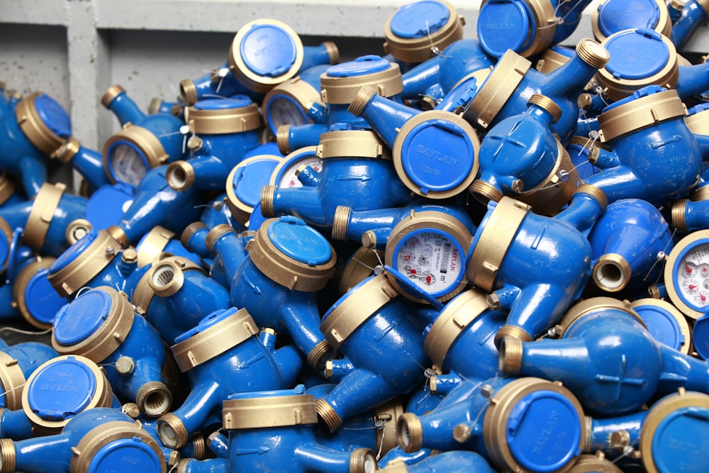 a pile of blue and gold clocks sitting on top of each other