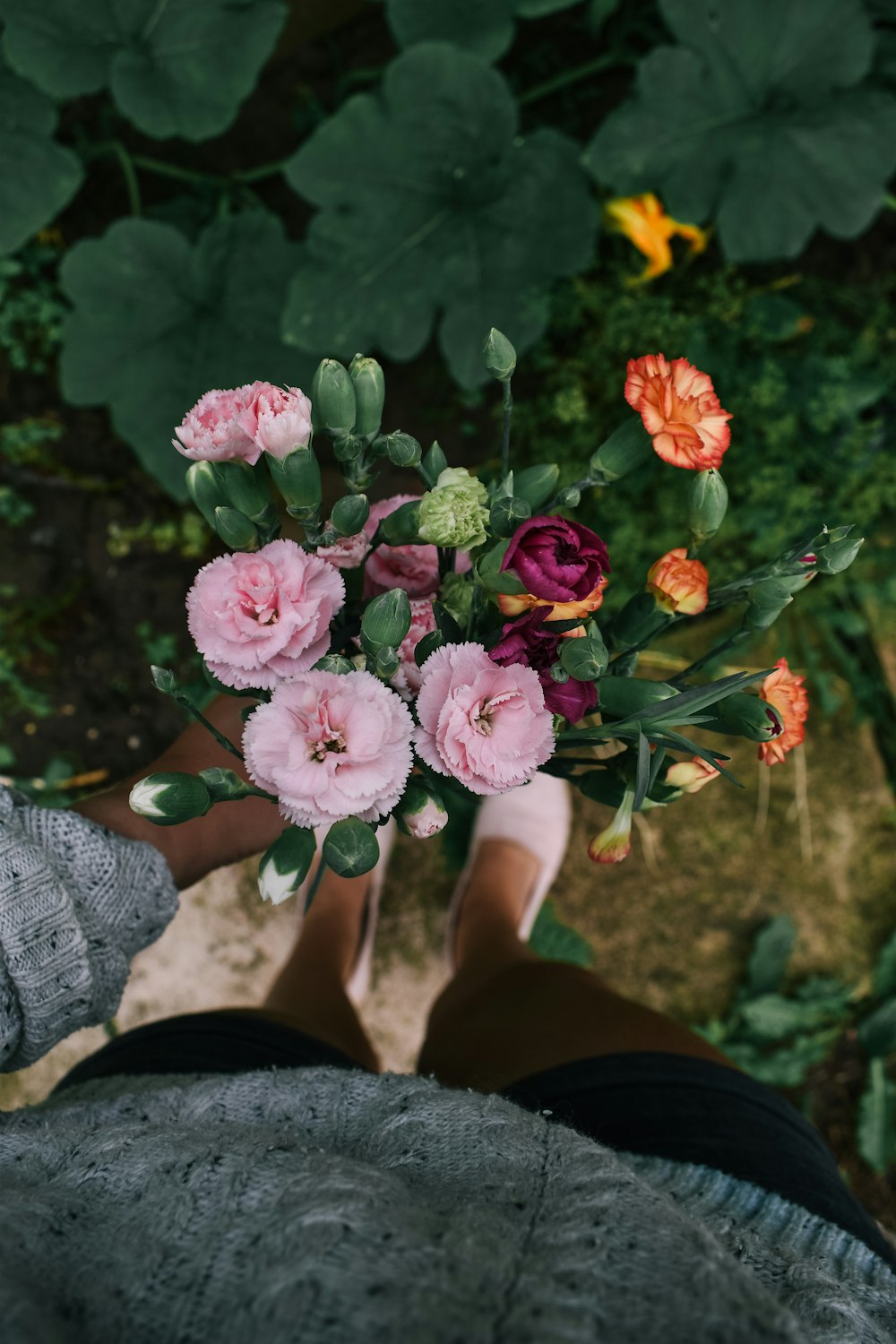 a person is holding a bouquet of flowers