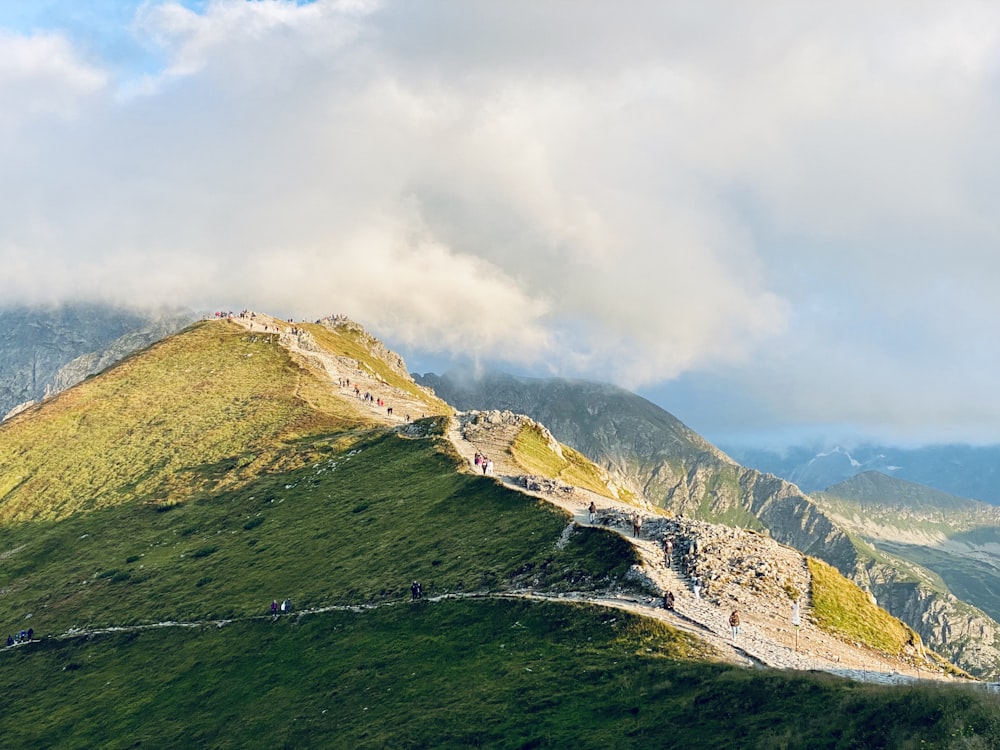 a group of people walking up the side of a mountain