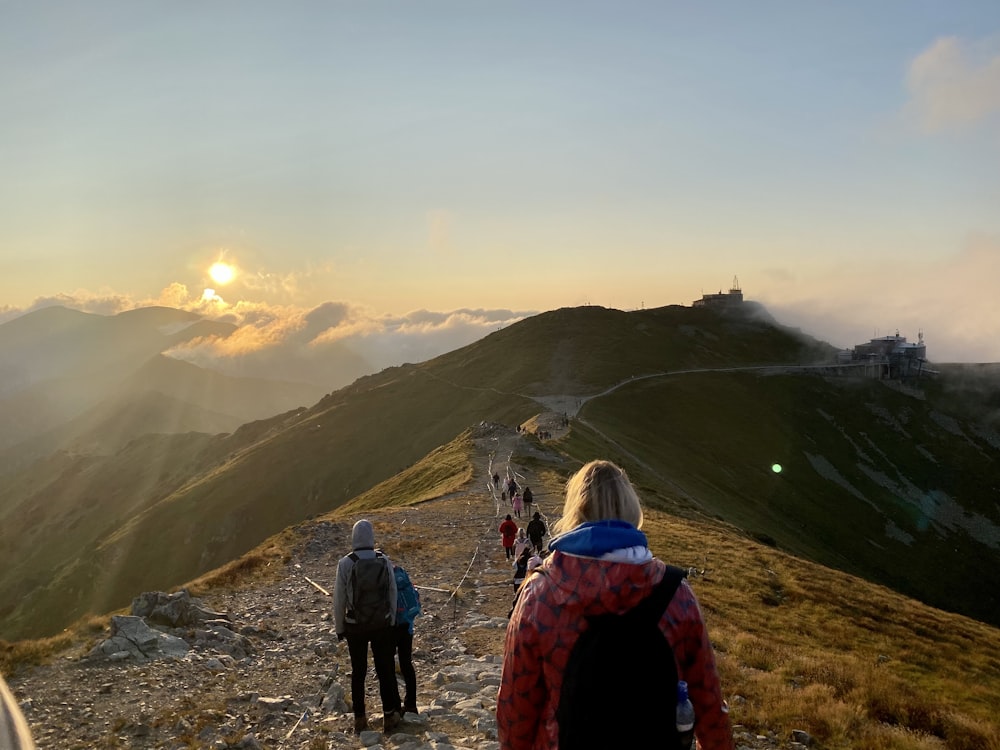 a group of people walking up a hill