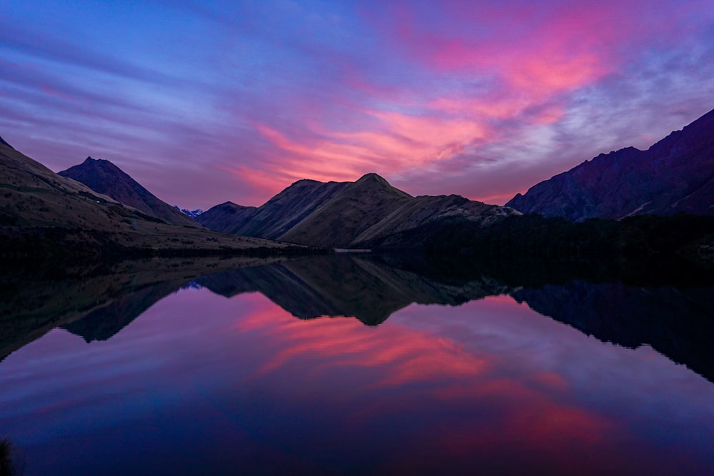 a lake with a mountain range in the background