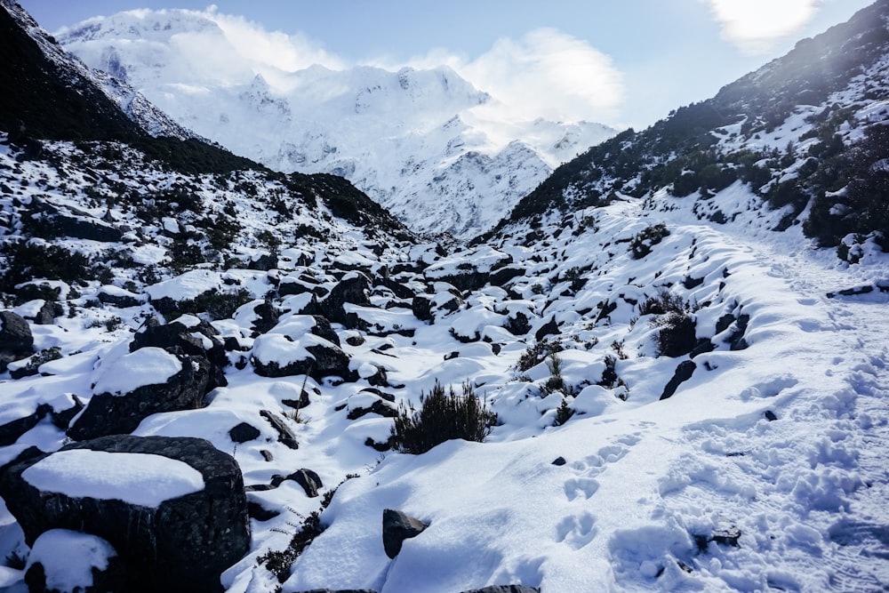 a mountain covered in snow and rocks under a blue sky