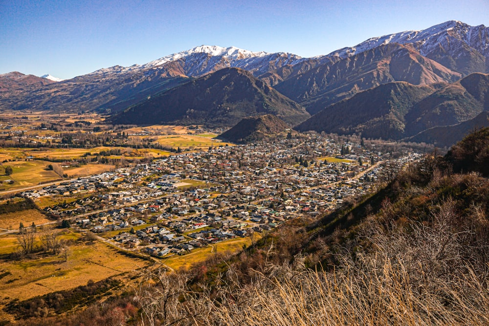 a scenic view of a city surrounded by mountains