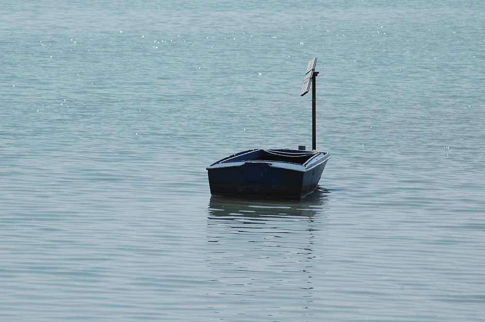 a small boat floating on top of a large body of water