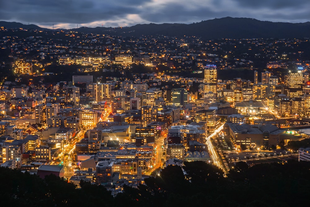 a view of a city at night from the top of a hill