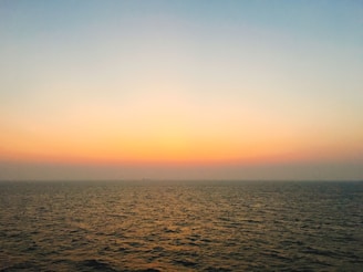 A calm ocean horizon at sunrise symbolizing steady and thoughtful investment growth.