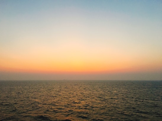 A calm ocean horizon at sunrise symbolizing steady and thoughtful investment growth.
