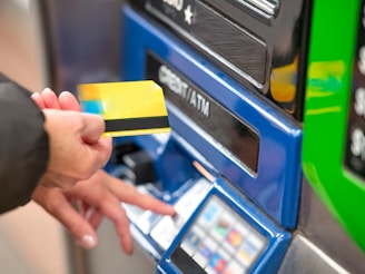 a person using a credit card to pay for a machine