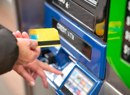 a person using a credit card to pay for a machine