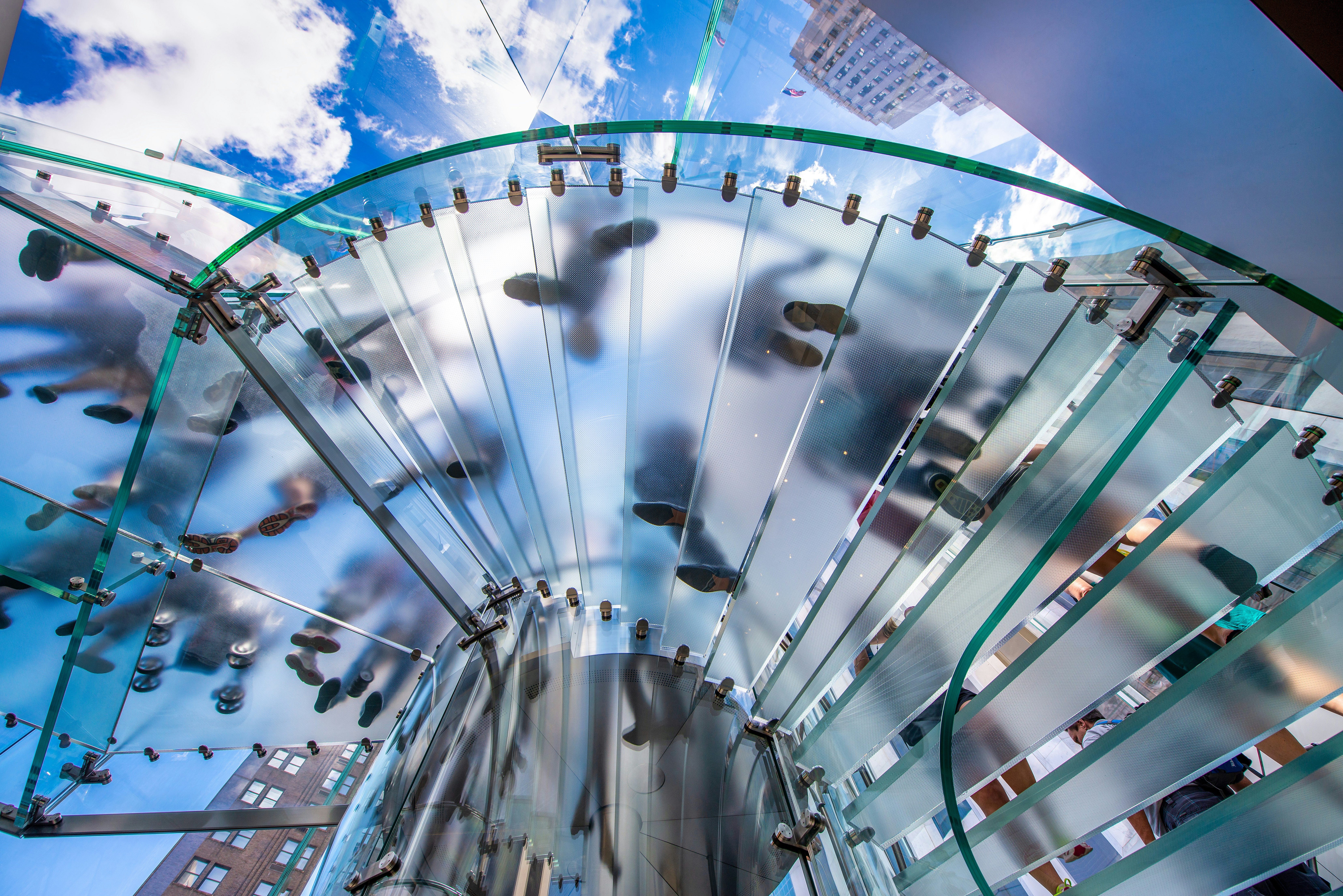 a glass staircase with a sky background
