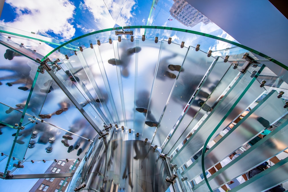 a glass staircase with a sky background