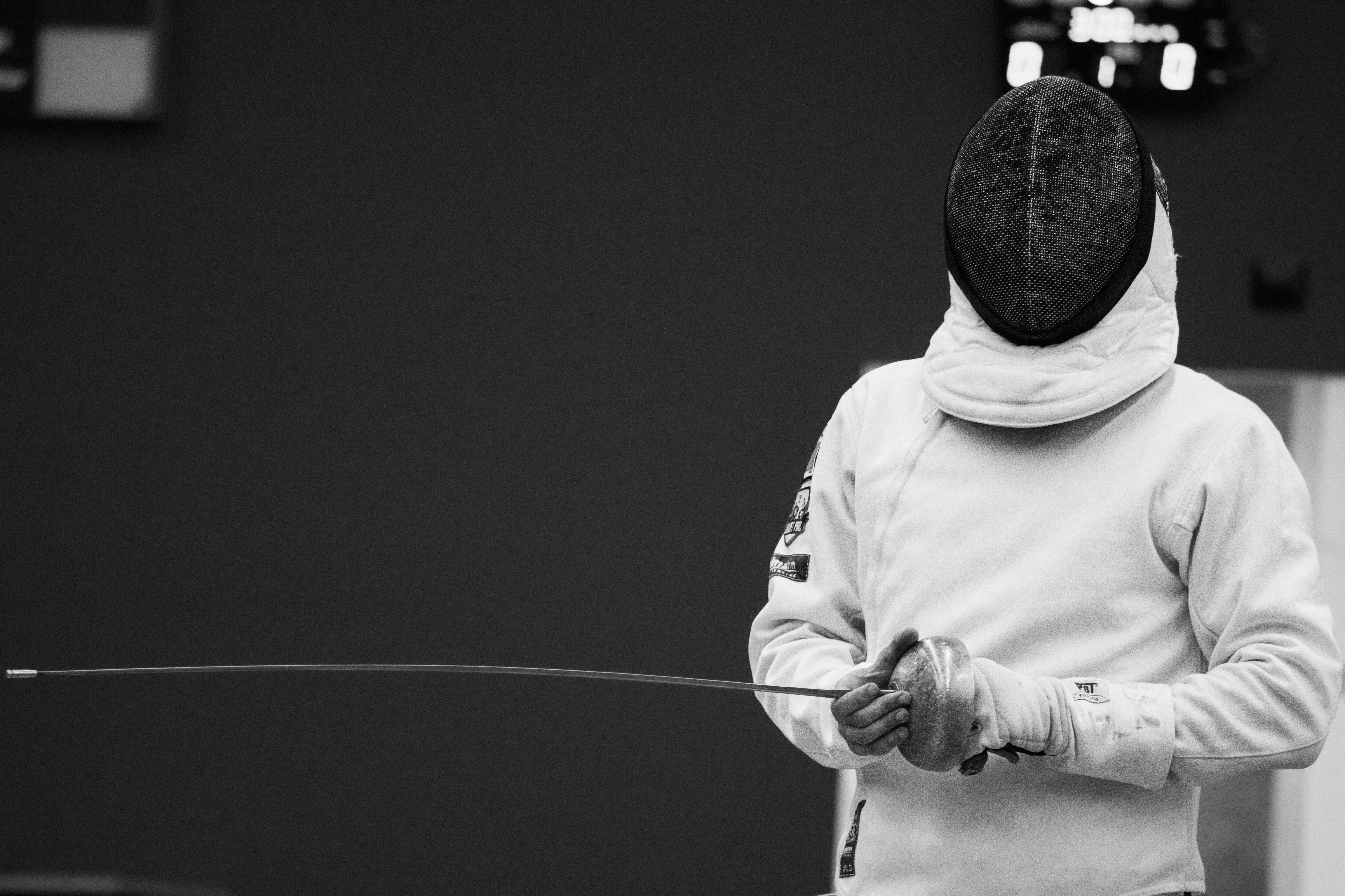 a man in a hoodie is holding a stick
