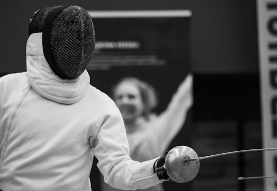a person in a white jacket is holding a ball
