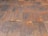 A close-up view of a corrugated metal roof with a rusted, aged appearance. The panels are aligned in a systematic pattern with alternating ridges and grooves. Various rust and weathering marks are present across the metal, adding texture and character.