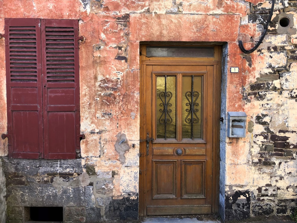 an old building with a wooden door and shutters