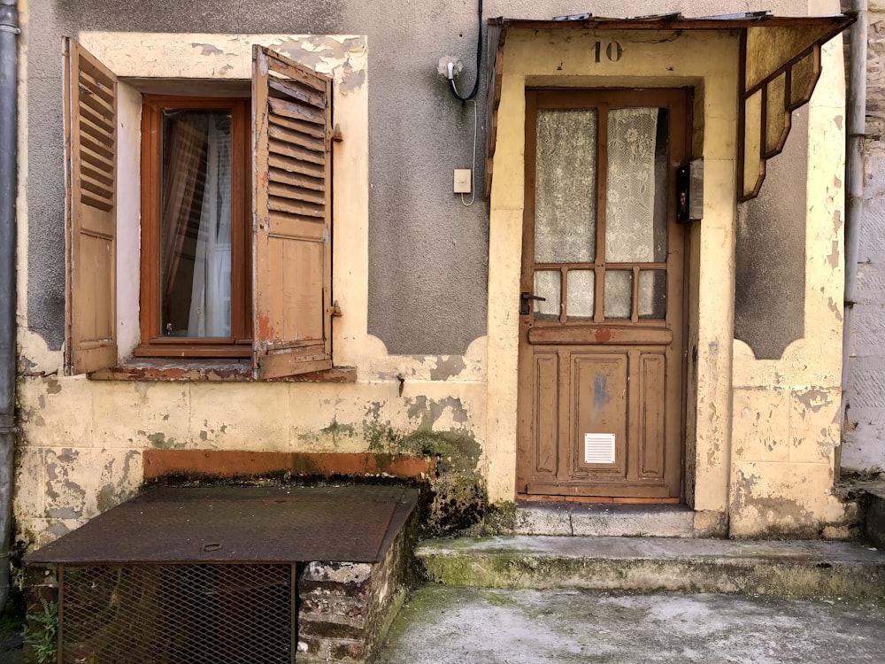 an old run down building with a bench in front of it