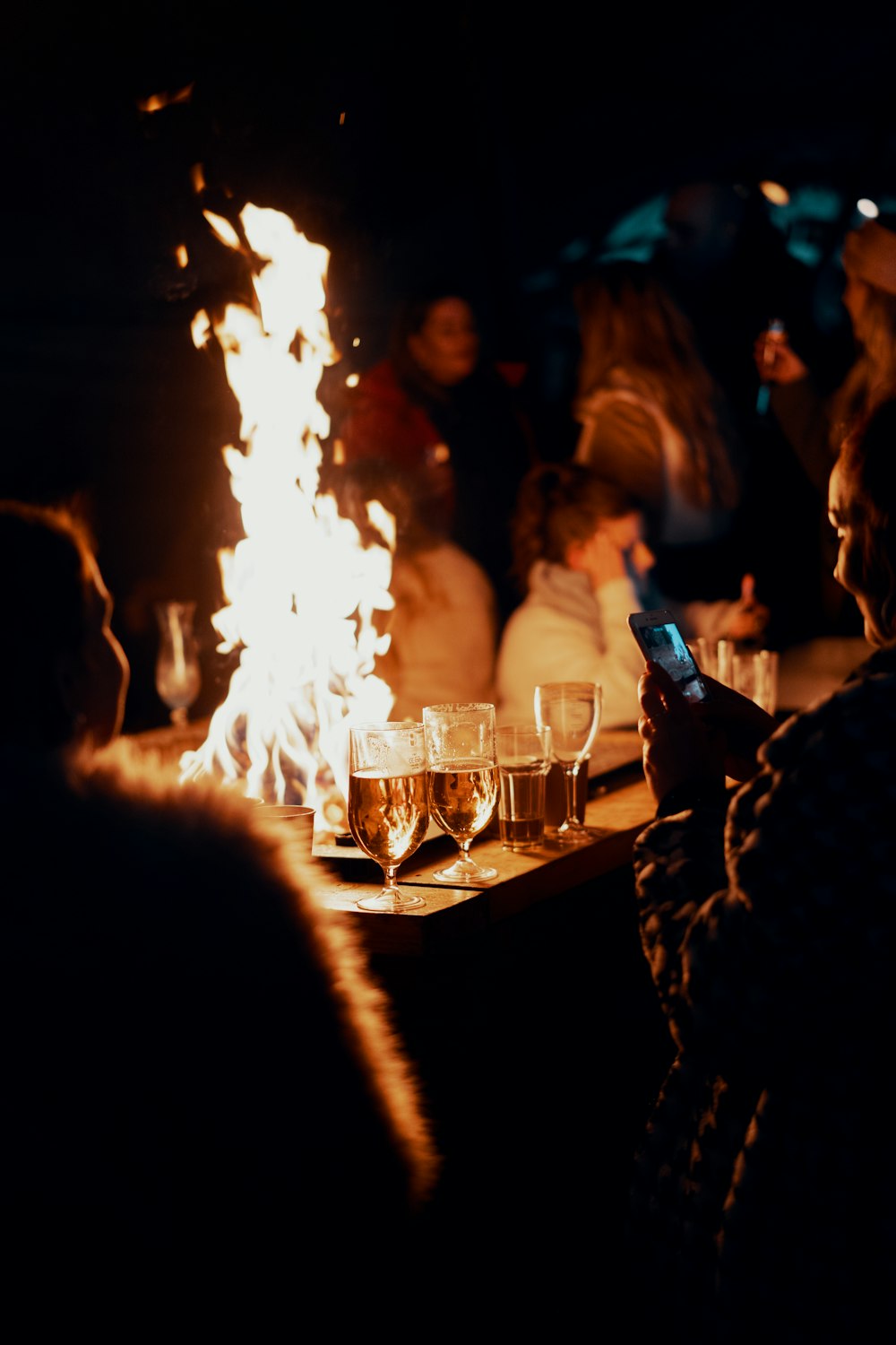 people sitting around table with fire