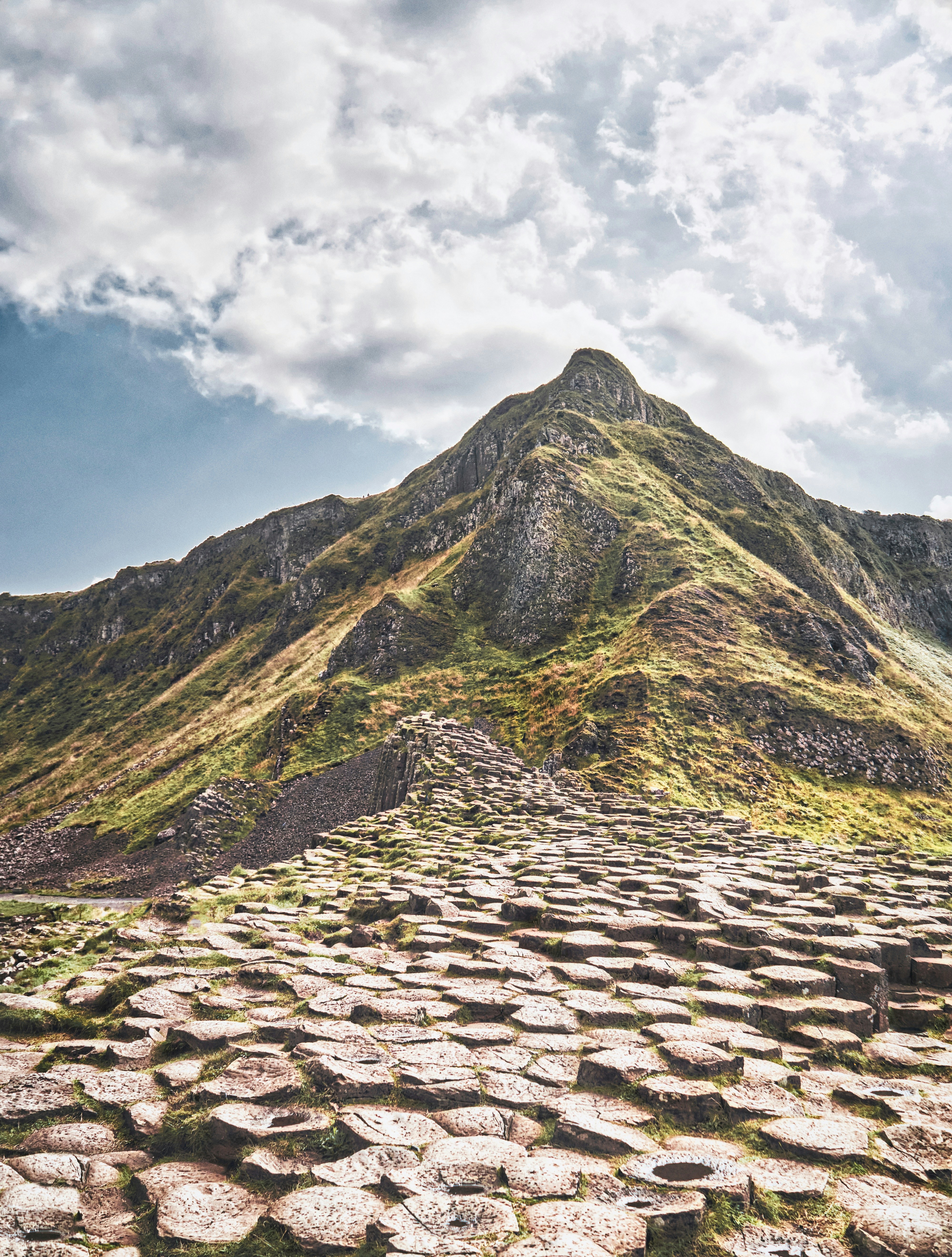 The hexagonal rocks formed by an ancient volcanic fissure leading up to the cliffs at the Giant's Causeway on the North coast in County Antrim (Sep., 2021). Read more about the Giant's Causeway here: https://giantscausewayofficialguide.com/about/myths-legends-of-the-causeway/
