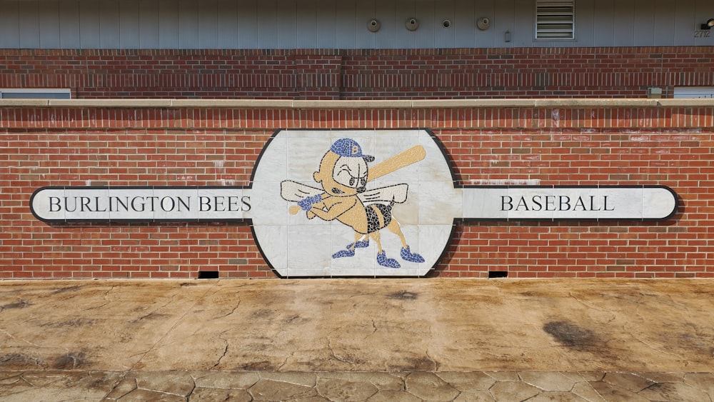 a brick wall with a sign for a baseball team