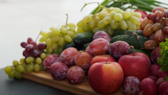 a variety of fruits and vegetables on a wooden tray