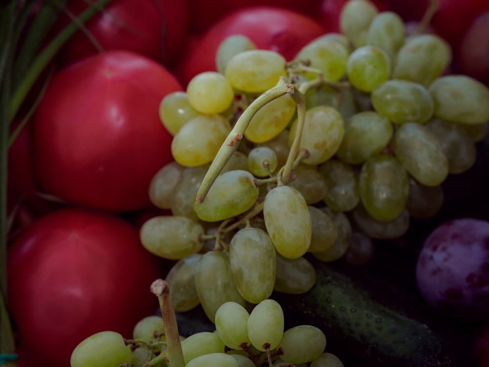 a close up of a bunch of grapes and cucumbers