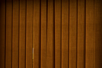 Elegant blackout roller blinds in deep charcoal blocking out all light