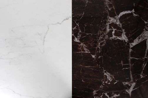 Side-by-side of a travertine countertop showing deep scratches and its polished finish after restoration.