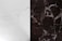 A surface divided into two contrasting marble textures, with the left side displaying a light-colored marble with subtle gray veining and the right side exhibiting a dark brown marble with prominent white veining.