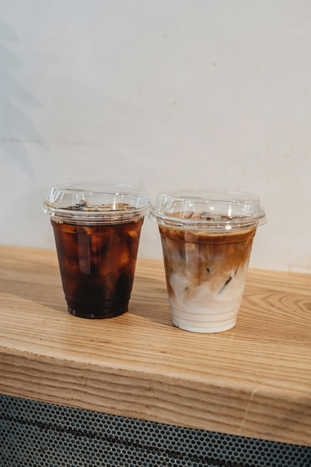 2 clear drinking glasses on brown wooden table