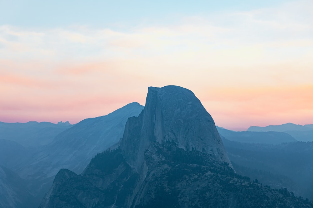 a view of the top of a mountain at sunset