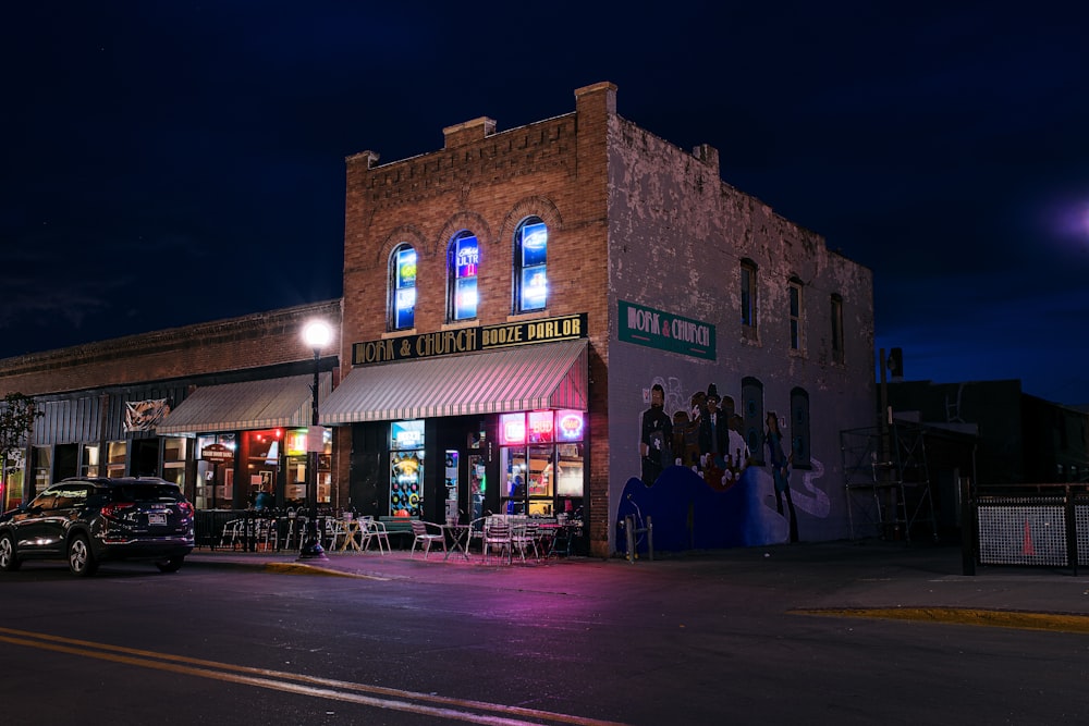 a street corner with a building and cars parked on the side of the road