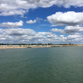A picturesque coastal scene with colorful beach huts.