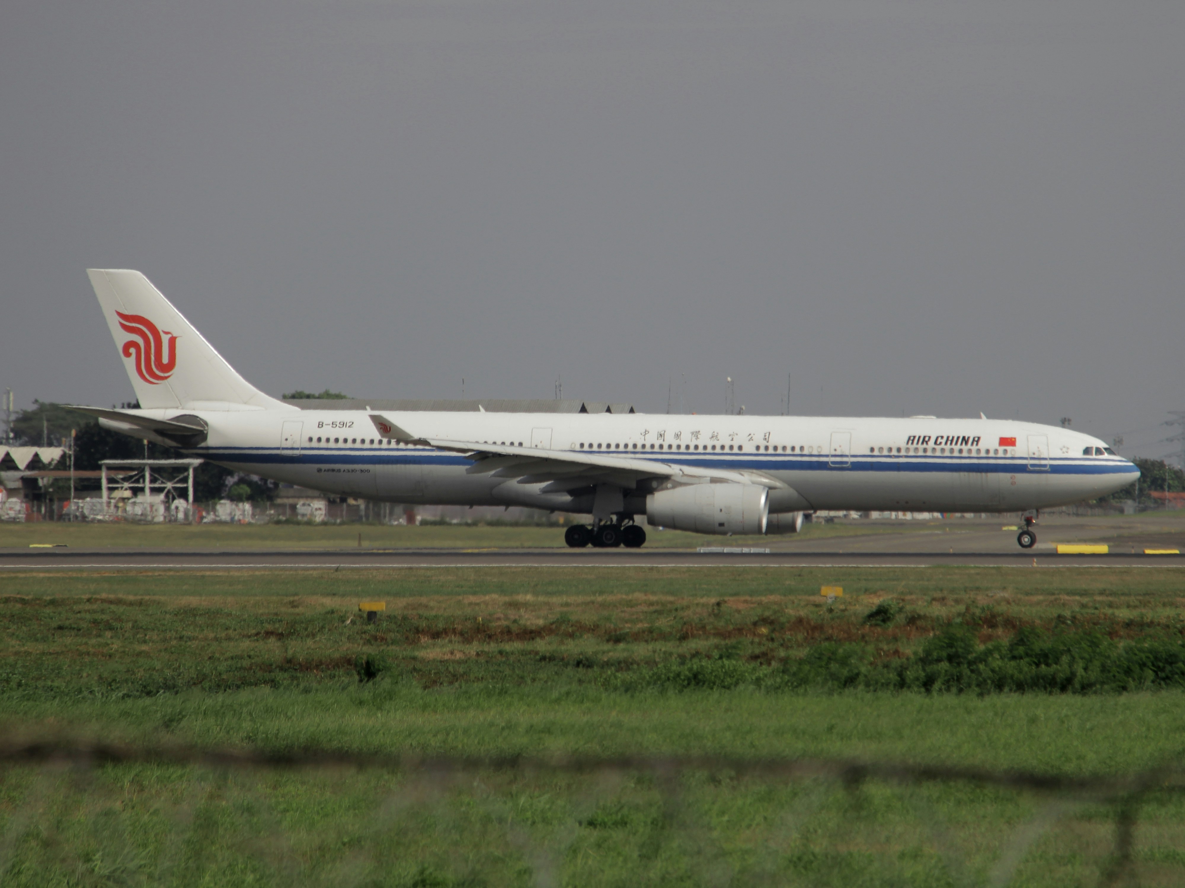 a large jetliner sitting on top of an airport runway, Air China Taxi to runway after delivering Covid vaccine for Indonesia