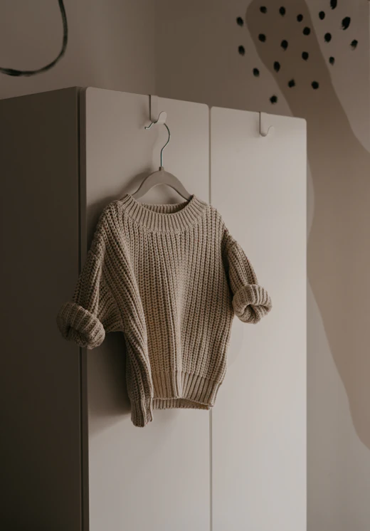 A cable knit jumper photographed for resale