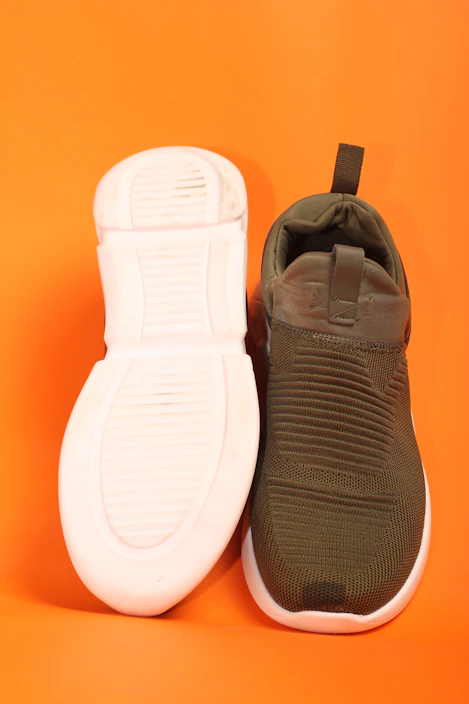 a pair of shoes sitting on top of an orange background