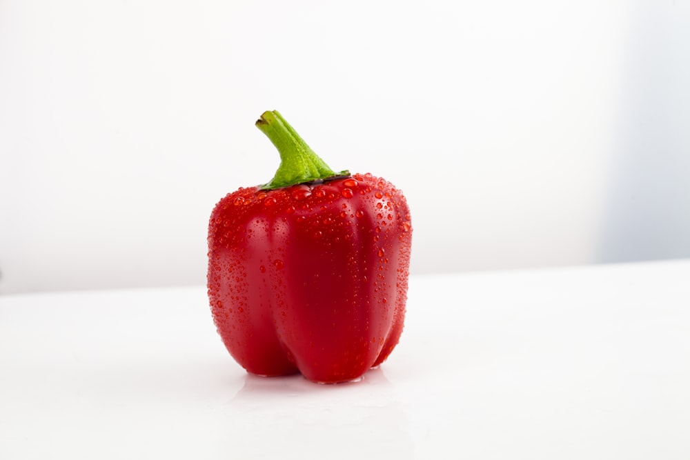 a red pepper sitting on top of a white counter