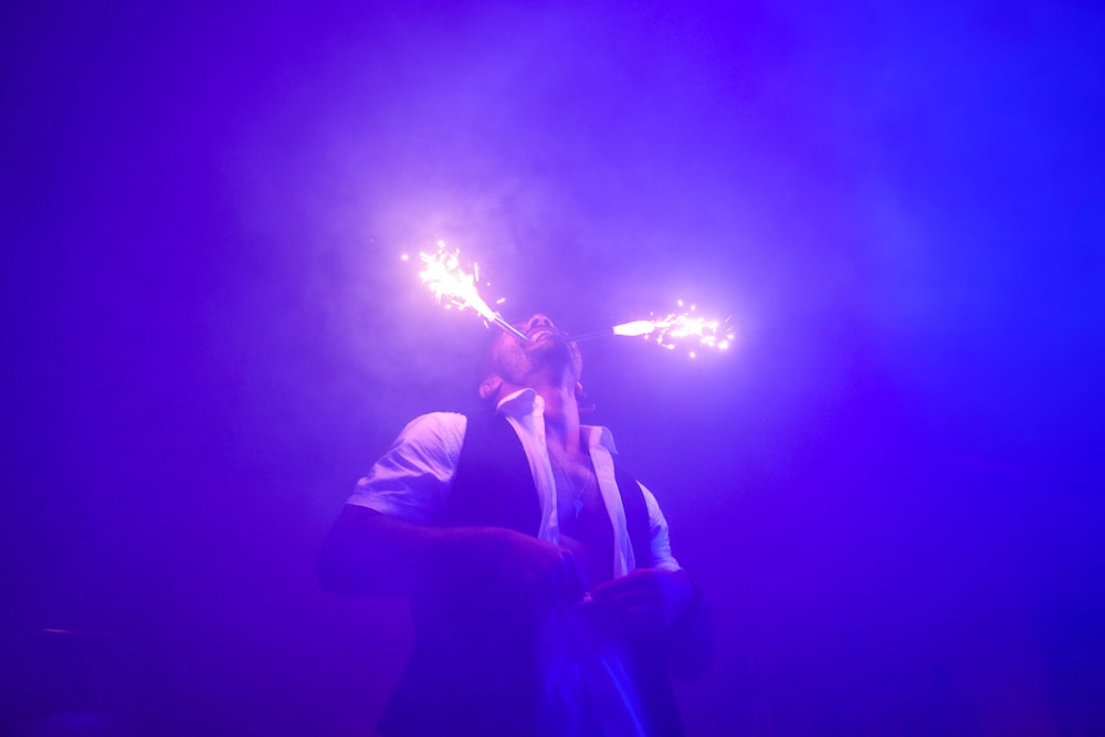 a man standing in front of a purple light