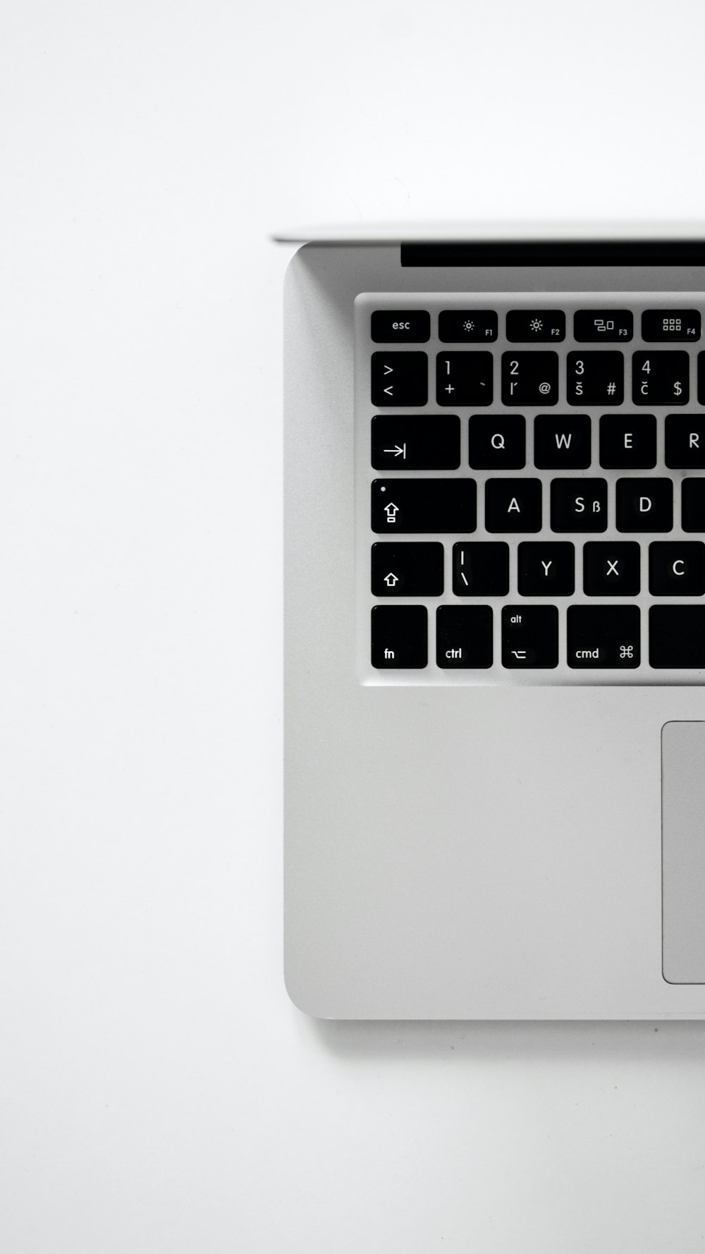 a laptop computer sitting on top of a white table