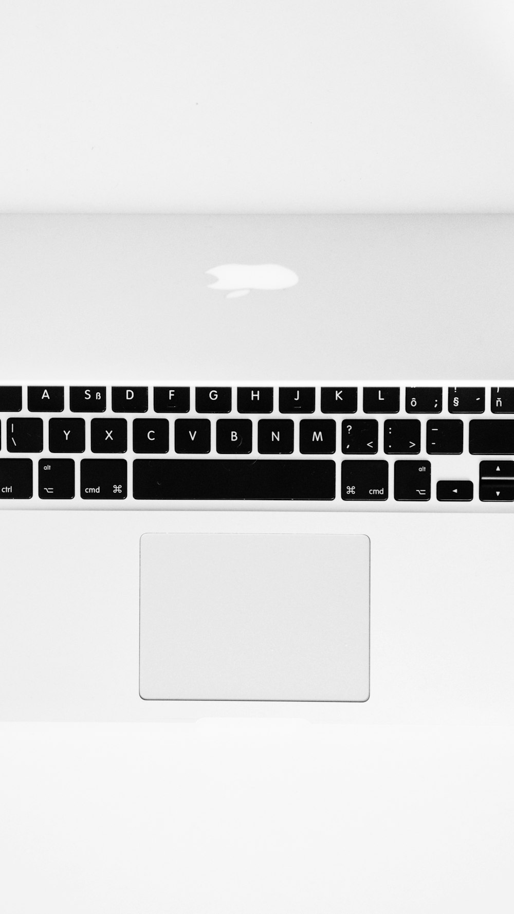 a white laptop computer with a black keyboard