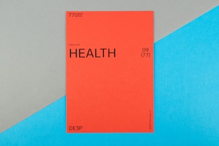 A vibrant red card with the word 'HEALTH' prominently displayed in black text, accompanied by smaller text indicating the number 09 (77) and phrases such as '77 HUMAN NEEDS' and '(physical)' at the top. The background consists of intersecting areas of blue and gray-green color.