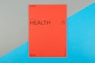 A vibrant red card with the word 'HEALTH' prominently displayed in black text, accompanied by smaller text indicating the number 09 (77) and phrases such as '77 HUMAN NEEDS' and '(physical)' at the top. The background consists of intersecting areas of blue and gray-green color.
