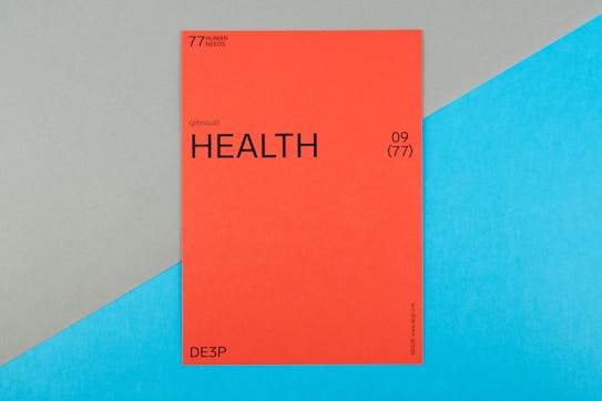 A vibrant red card with the word 'HEALTH' prominently displayed in black text, accompanied by smaller text indicating the number 09 (77) and phrases such as '77 HUMAN NEEDS' and '(physical)' at the top. The background consists of intersecting areas of blue and gray-green color.