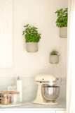 Close-up of sleek kitchen gadgets and utensils neatly displayed on a marble countertop.