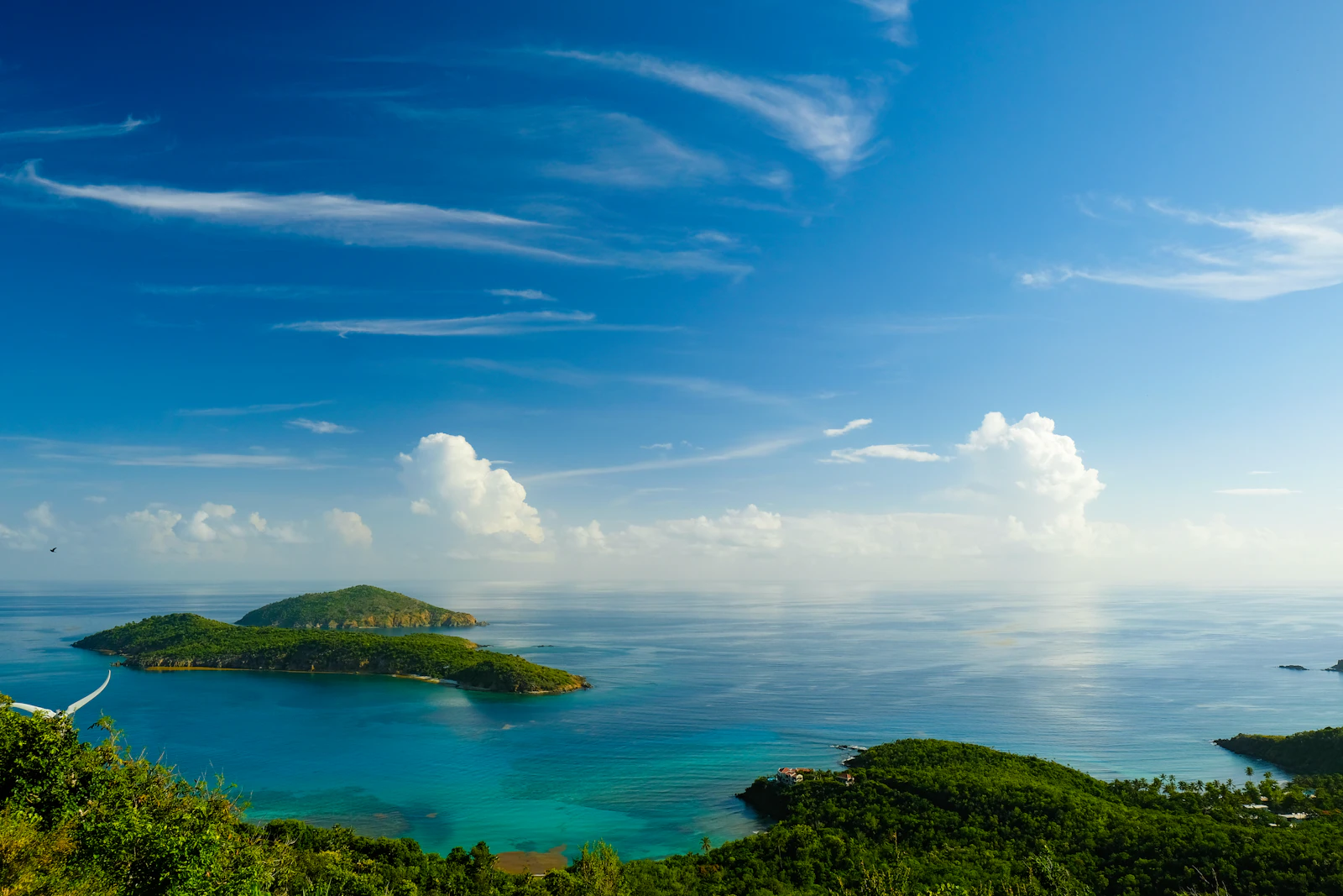 Aerial view of a lush green tropical island surrounded by turquoise Caribbean waters near Saint Thomas, US Virgin Islands, no people visible