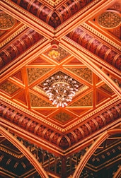 a ceiling with a chandelier hanging from it