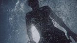 a man standing in the water in the ocean