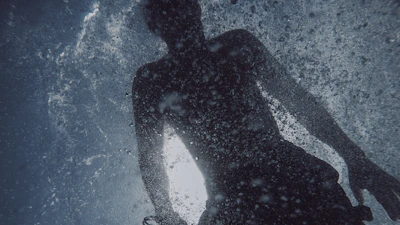 a man standing in the water in the ocean