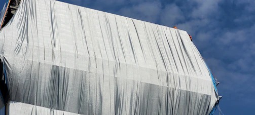 A premium tent structure set up at a construction site with workers.