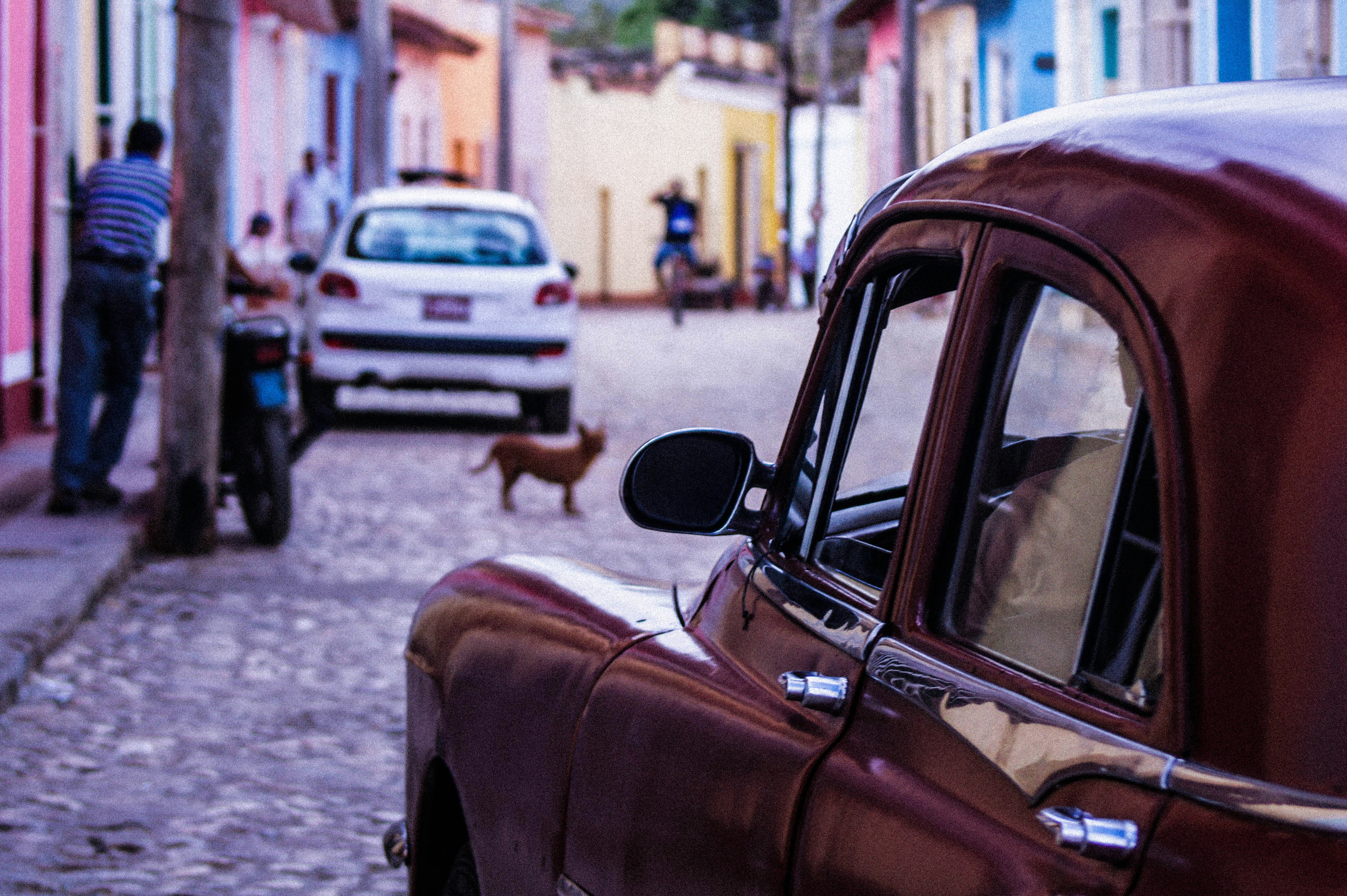 a red car parked on the side of a street